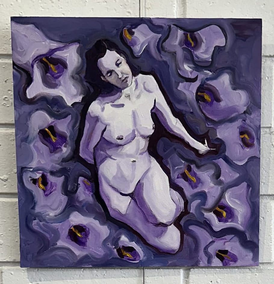 A purple nude reclines on a sea of larger than life Jacaranda flowers
